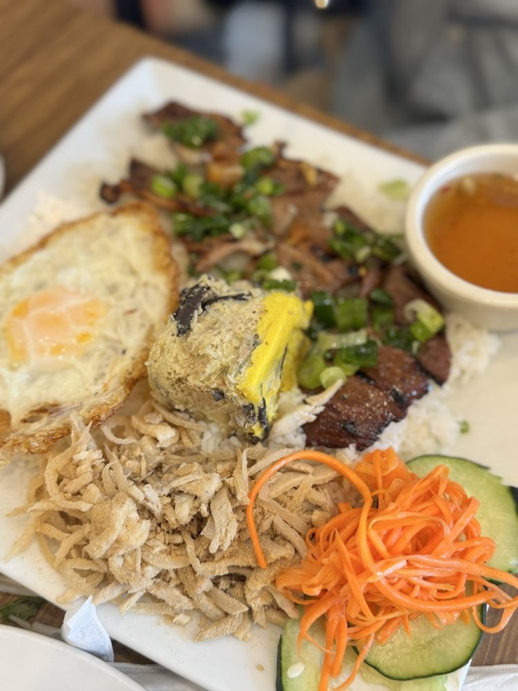 Combination broken rice with grilled pork, fried egg, pork-egg custard, shredded pork, pickled vegetables, and fish sauce
