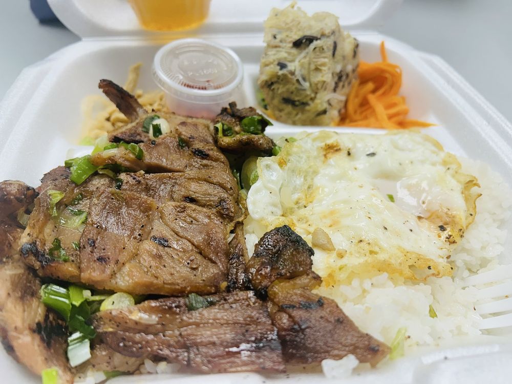 Combination broken rice plate with grilled pork, fried egg, and pickled vegetables